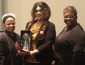 Three individuals, center Hazel Edwards receives award