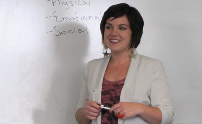 Photo of individual training in front of a whiteboard