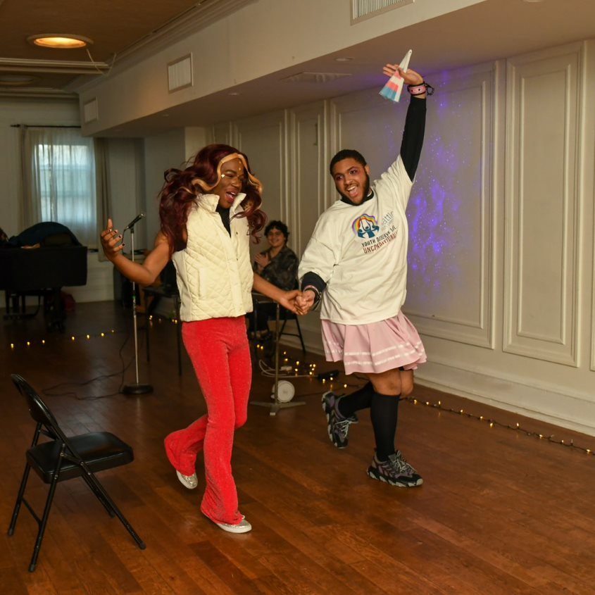 Two youth dancing together during a drag performance